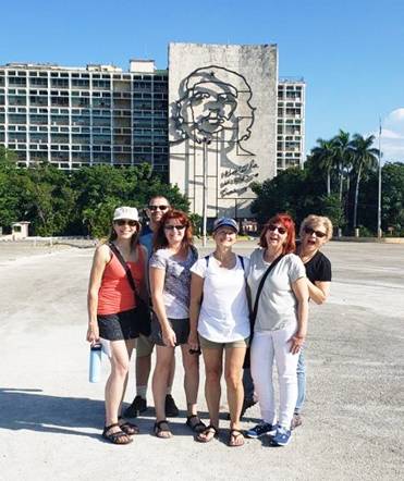 A group of travelers visiting the Plaza de la Revolucion in Havana
