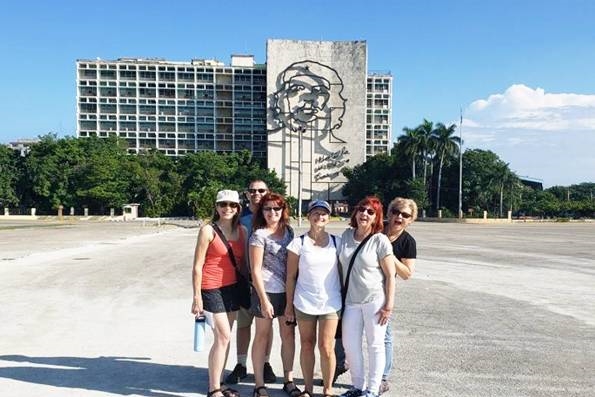 A group of travelers visiting the Plaza de la Revolucion in Havana