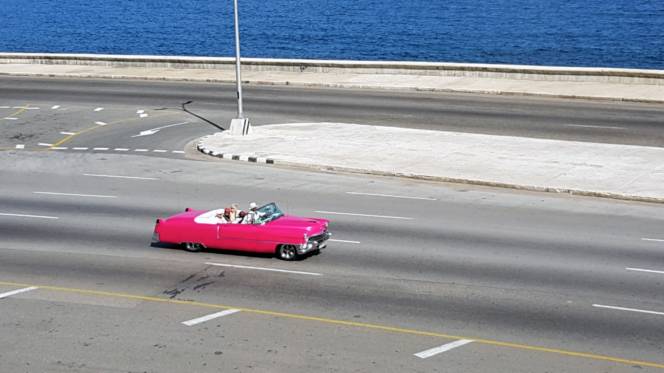 A 1950's pink Cadillac on the Malecon in Havana A 1950's pink Cadillac on the Malecon in Havana