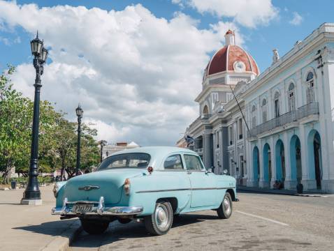 A blue 1950’s Chevrolet parked in the main square in Cienfuegos, Cuba