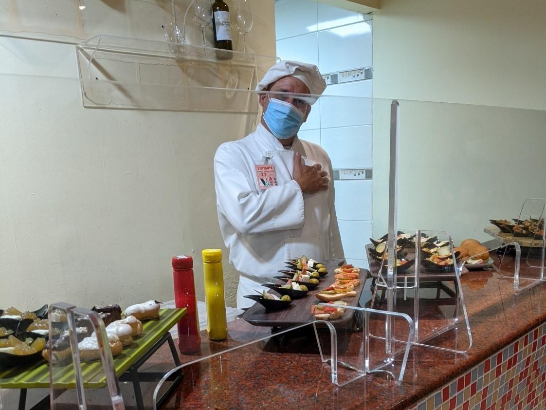 A chef displays an assortment of snacks