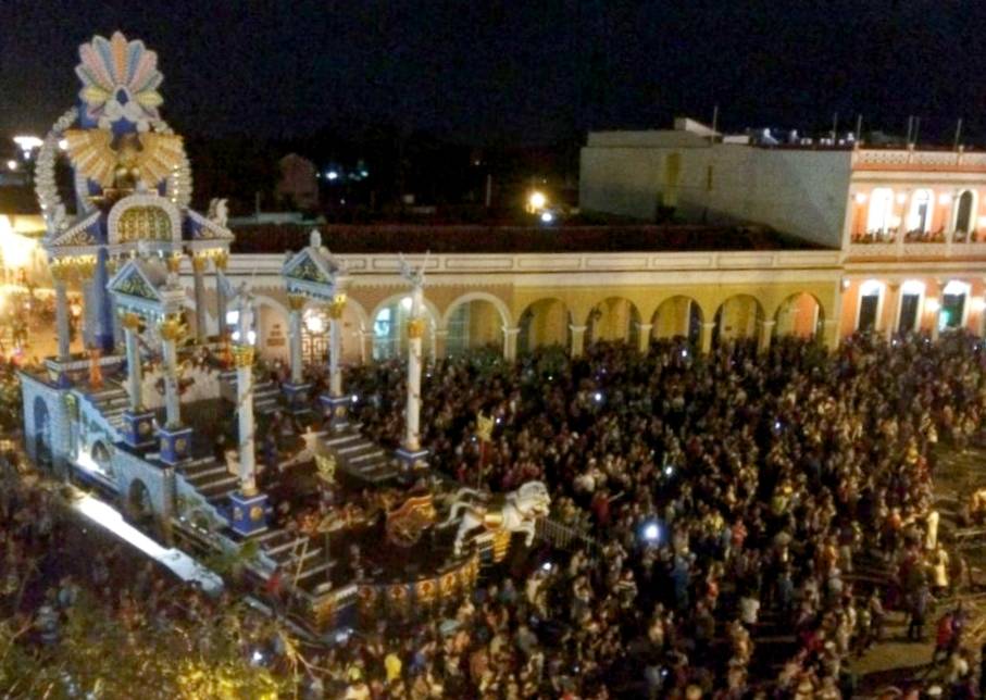 A crowd gathers in the main square of Remedios in front of a large carnival float. A crowd gathers in the main square of Remedios in front of a large carnival float.