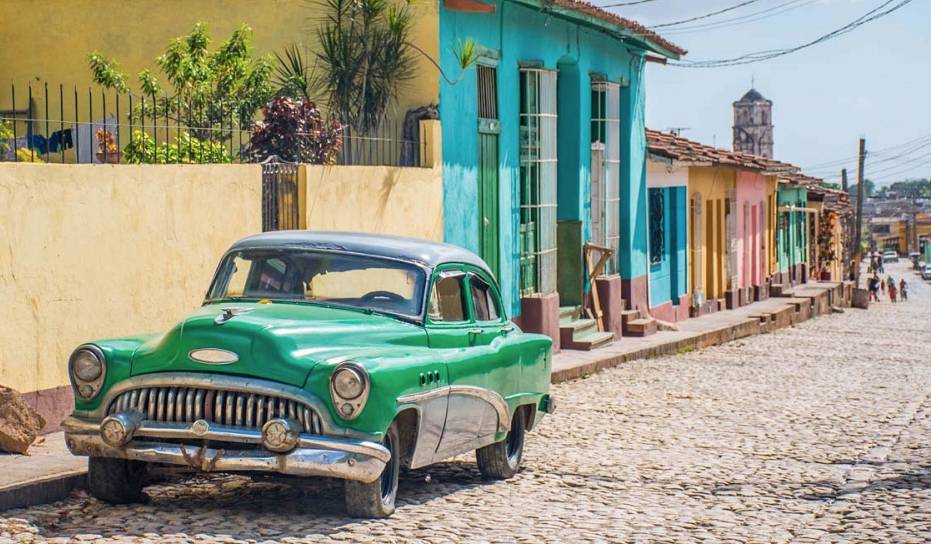 A green 50’s classic Buick car parked on a cobblestone street in Trinidad, Cuba A green 50’s classic Buick car parked on a cobblestone street in Trinidad, Cuba