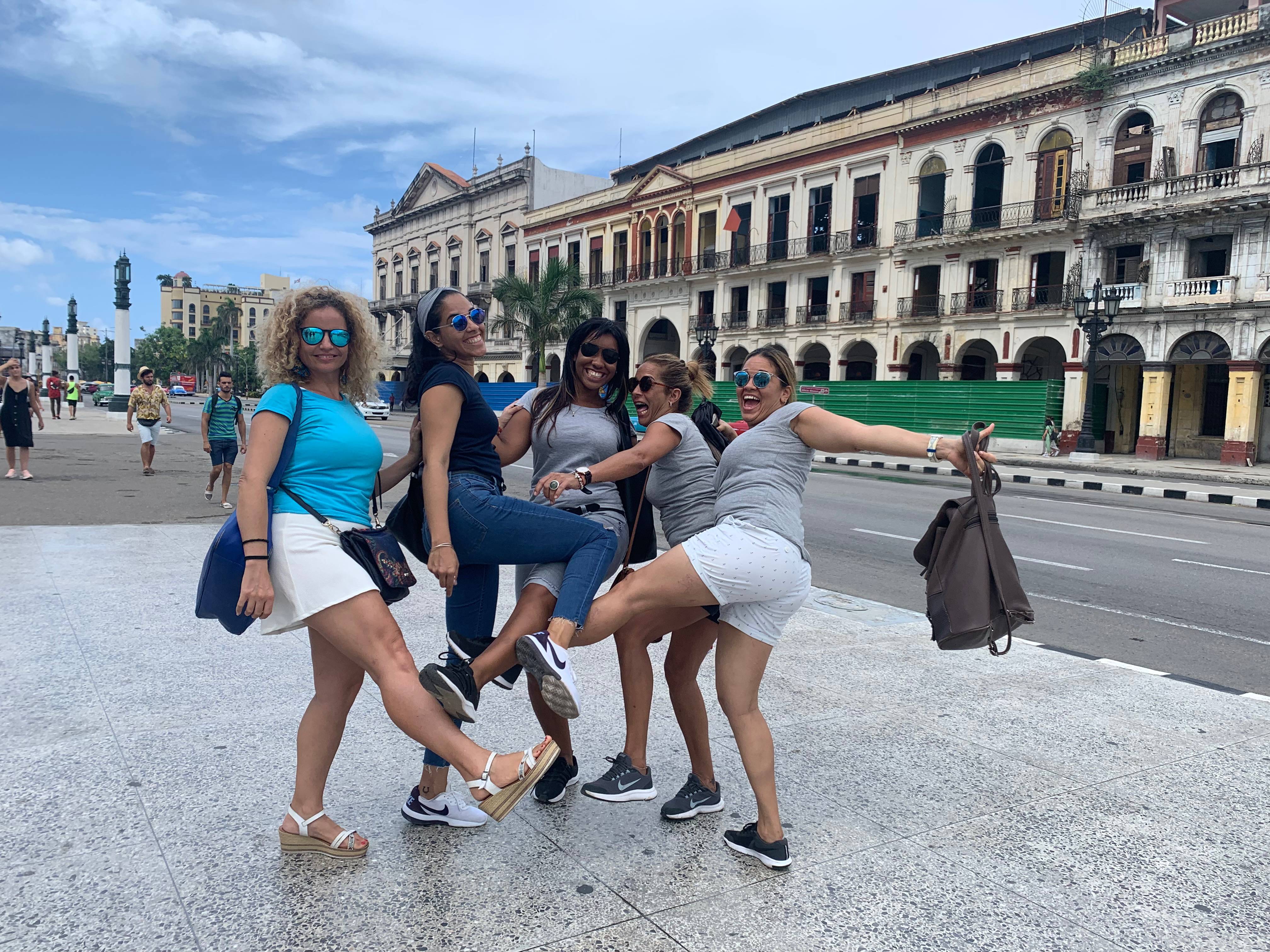 A group of female guides clowns around on a Havana street A group of female guides clowns around on a Havana street