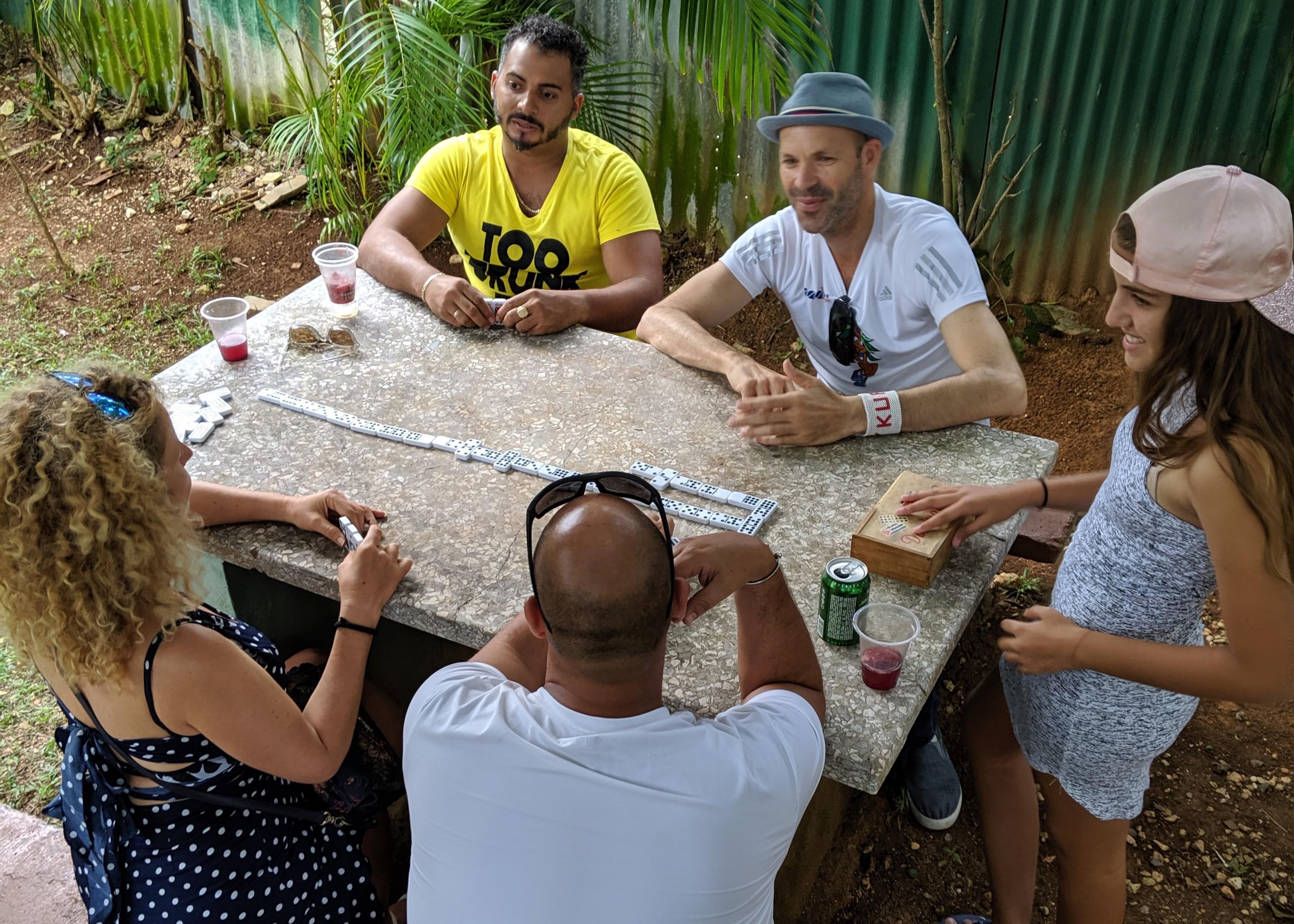 a group of people playing dominos outside