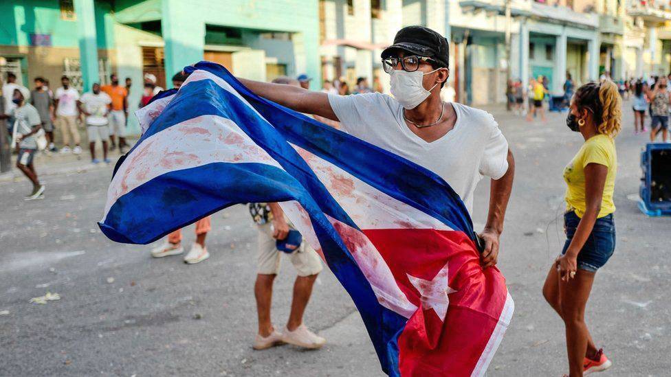 A man with a Cuban flag in the July 11 protest in Havana. Photo: Adalberto Roque—AFP/Getty A man waves a Cuban flag in a protest in the July 11 protest in Havana