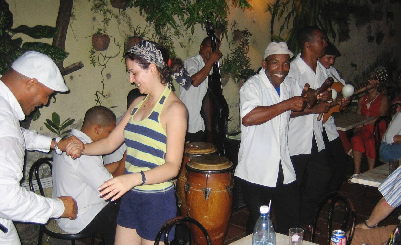 A small live music venue in Santiago de Cuba A salsa band performing in a small venue in Santiago de Cuba