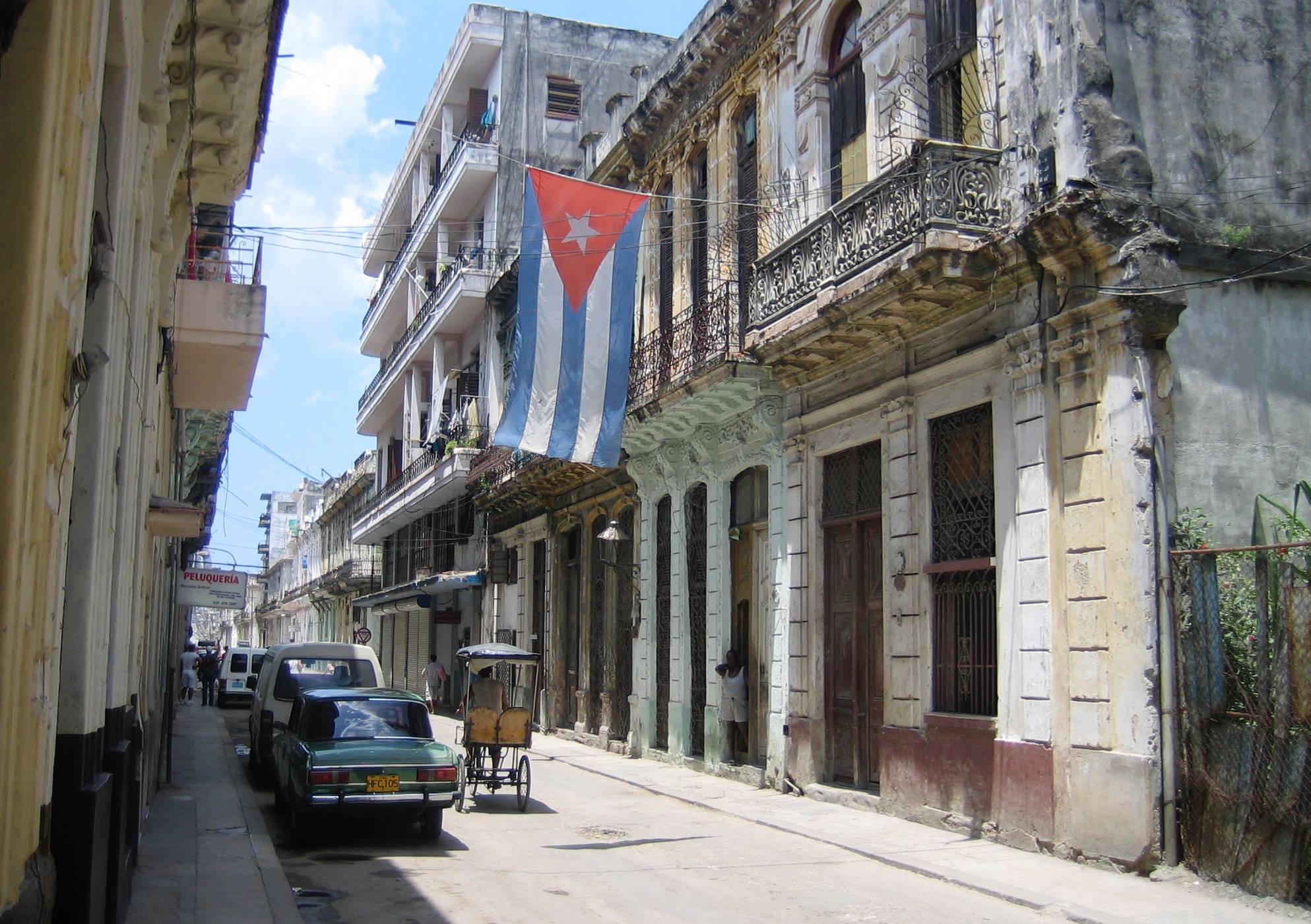 Cuba, Havana. Fortress wall and Cuban flag at San Carlos de