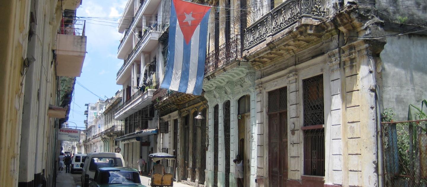 A street scene with Cuban flag in Central Havana, Cuba