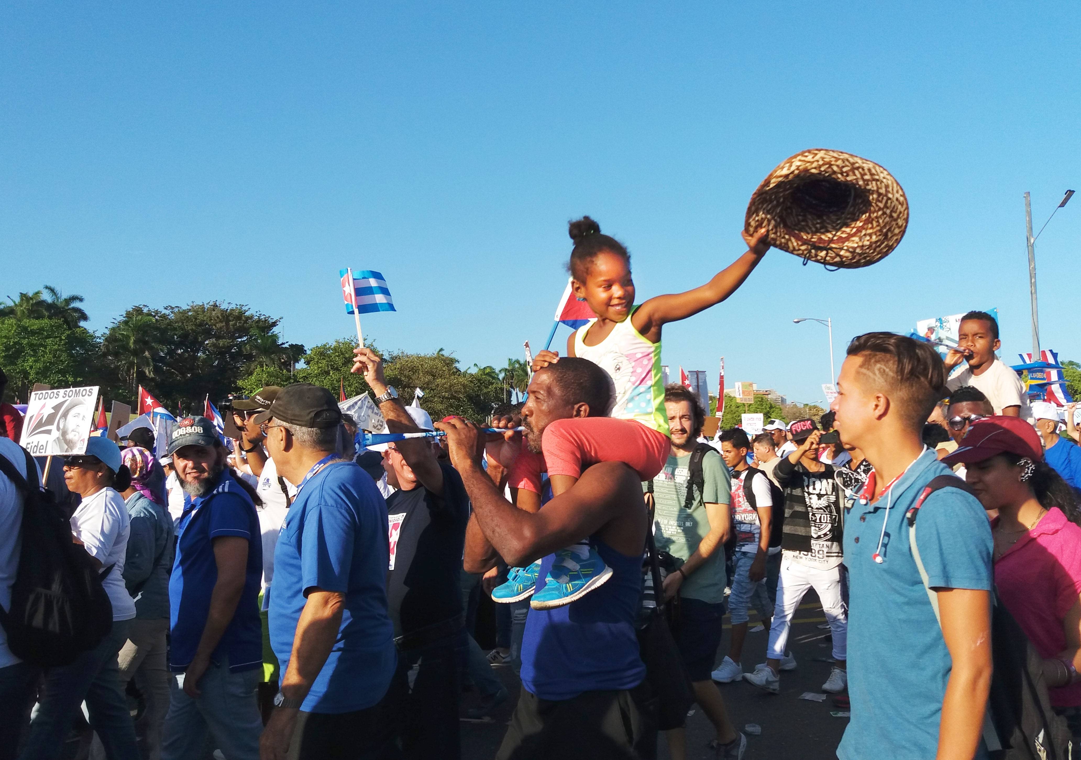 A young girl rides on her father’s shoulders during crowd the May Day Parade in Havana A young girl rides on her father’s shoulders during crowd the May Day Parade in Havana