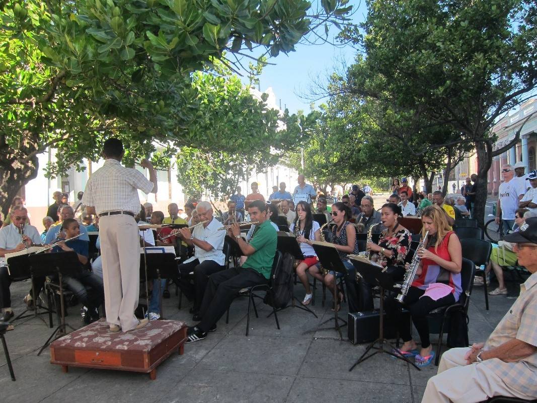 An orchestra practicing on a tree lined paseo an orchestra practicing on a tree lined paseo