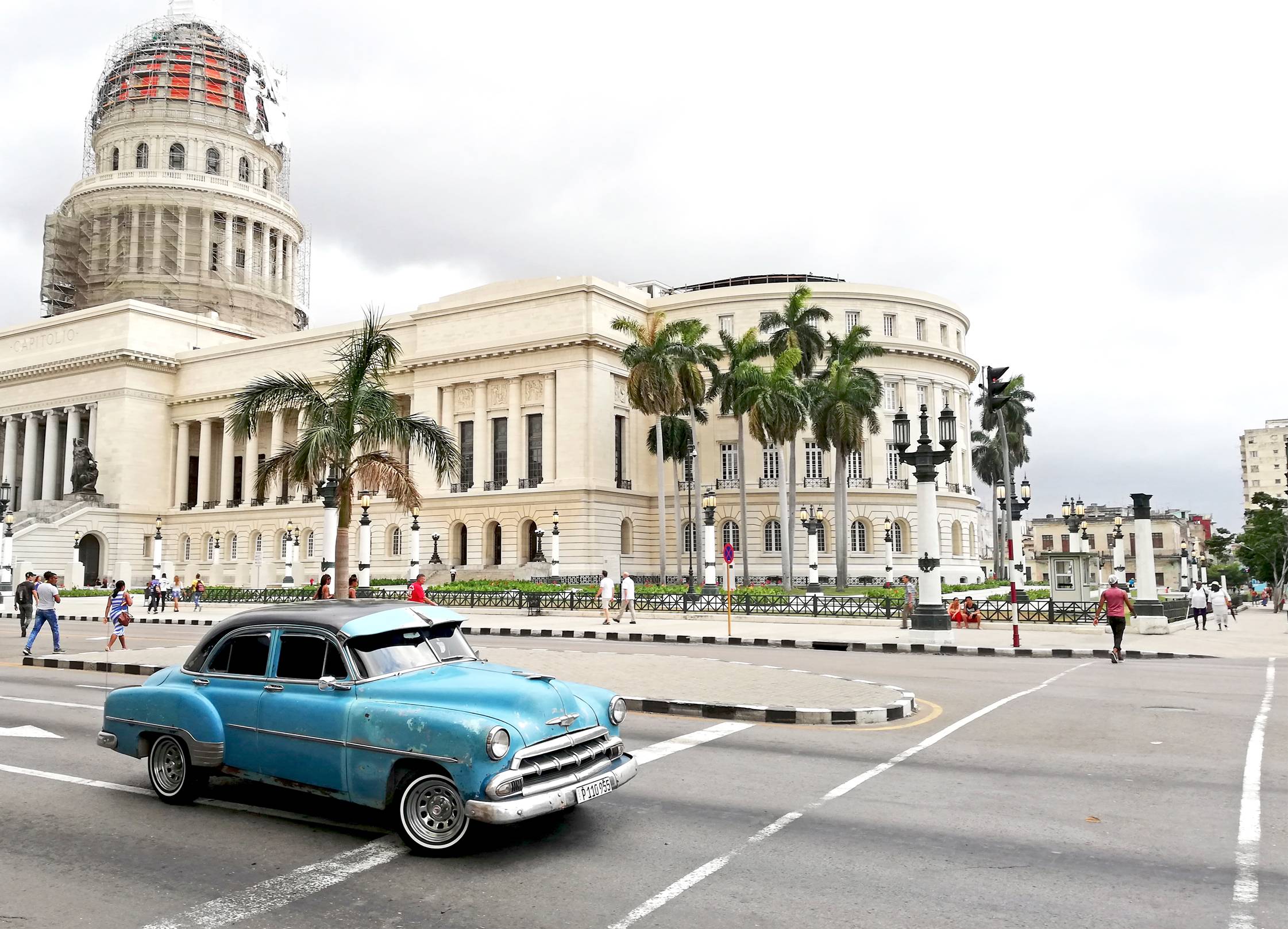 Antique blue car outside of the Havana Capitol building Antique blue car outside of the Havana Capitol building