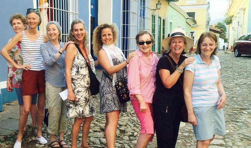 A Cuban Adventures tour group with their guide, Natalia, posing in the street in Trinidad, Cuba