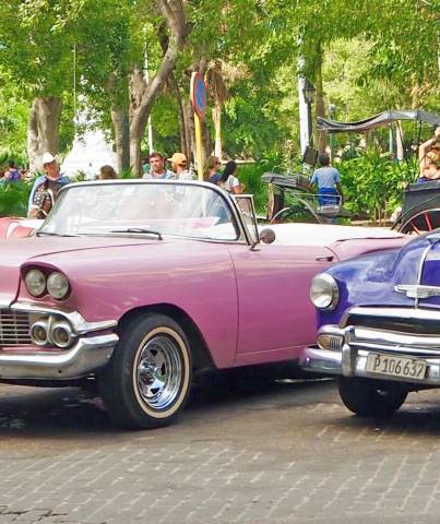 Classic American 50s taxis waiting for tourists in Havana