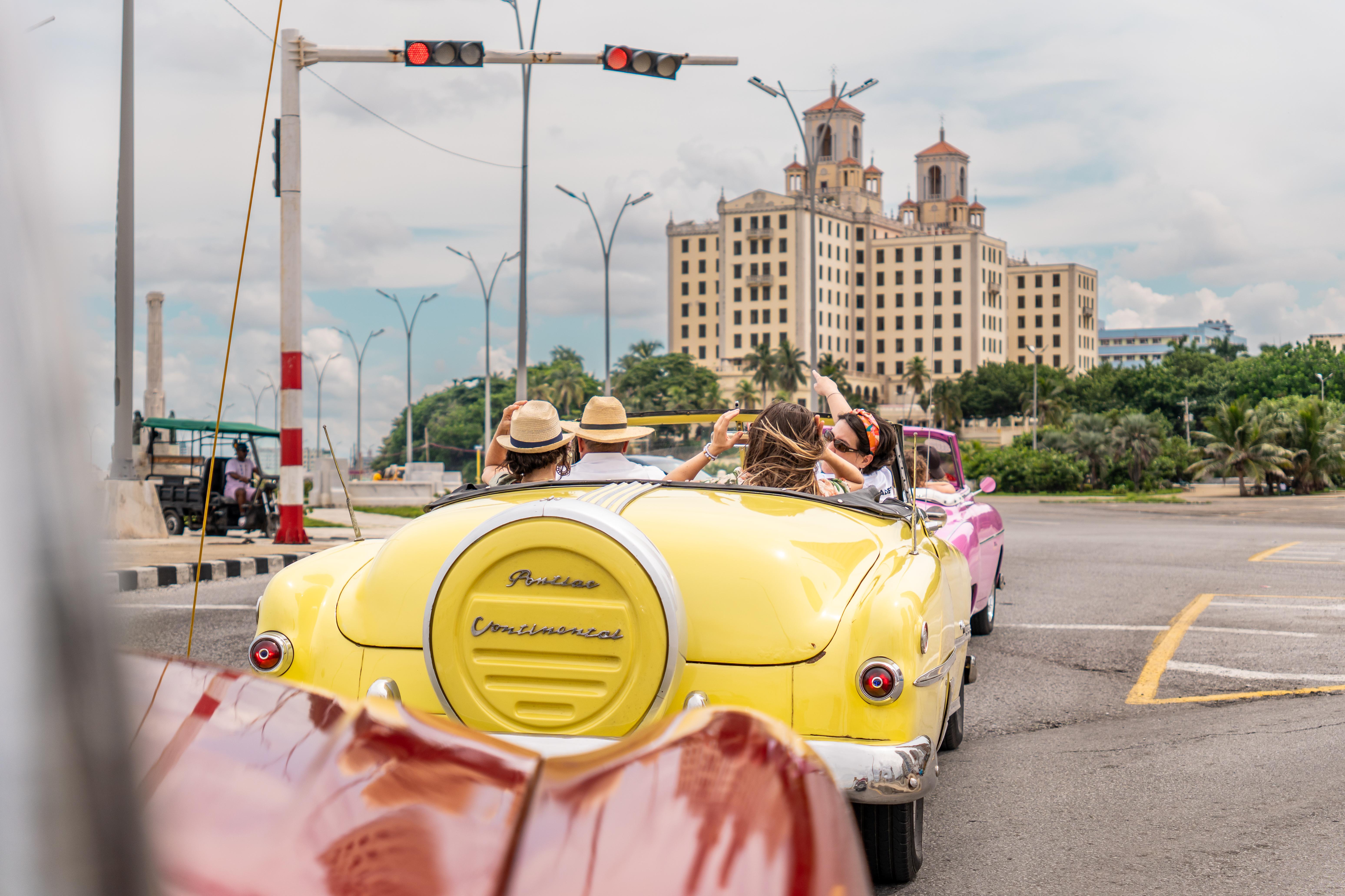 Cruising toward Havana's Hotel Nacional in a yellow convertible