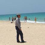 Cuban policeman patrolling the beach Cuban policeman patrolling the beach