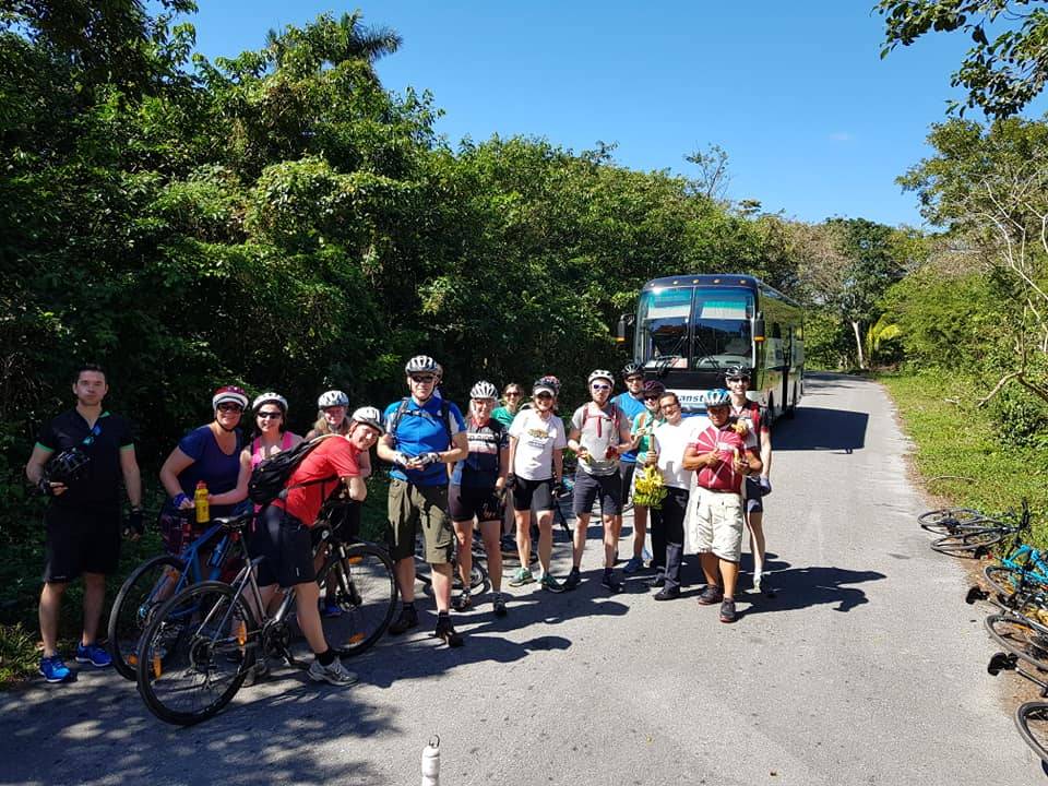 cycling group gathered in front of tour bus cycling group gathered in front of tour bus