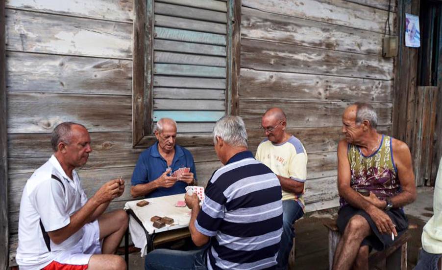 Men playing dominoes on a front porch in Baracoa Men playing dominoes on a front porch in Baracoa