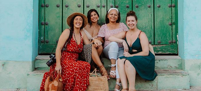 Girls sitting in front of green door