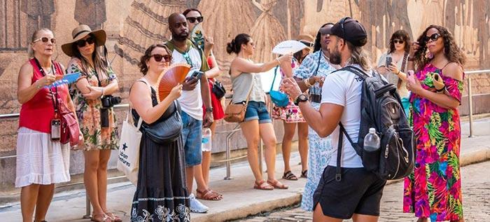 Group in front of wall mural in Habana Vieja