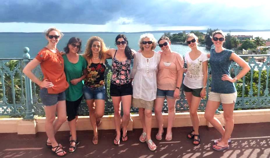 Group of women poses near railing in Cienfuegos Group of women poses near railing in Cienfuegos
