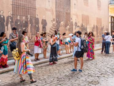 Group with tour leader by Historic Wall Mural