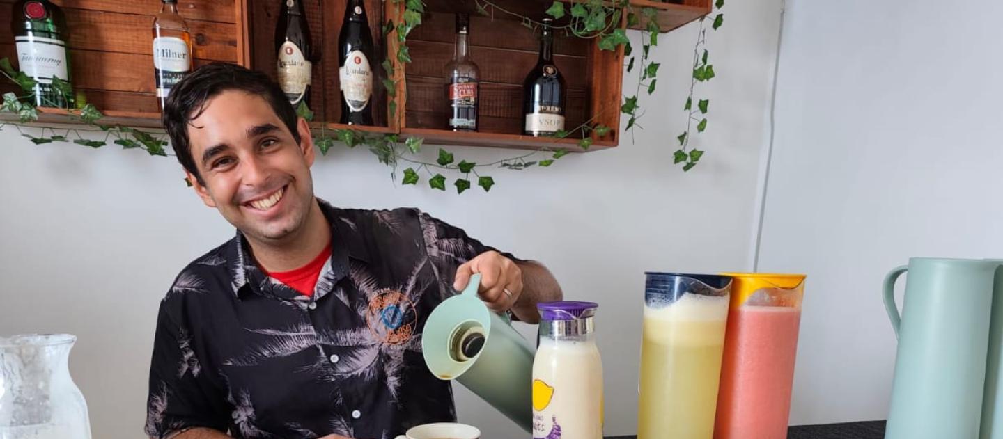 Host serving a colorful Cuban breakfast spread at Malecon Sunset guesthouse in Havana