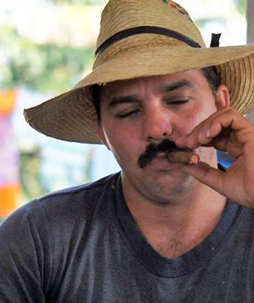 A Cuban farmer smokes a cigar