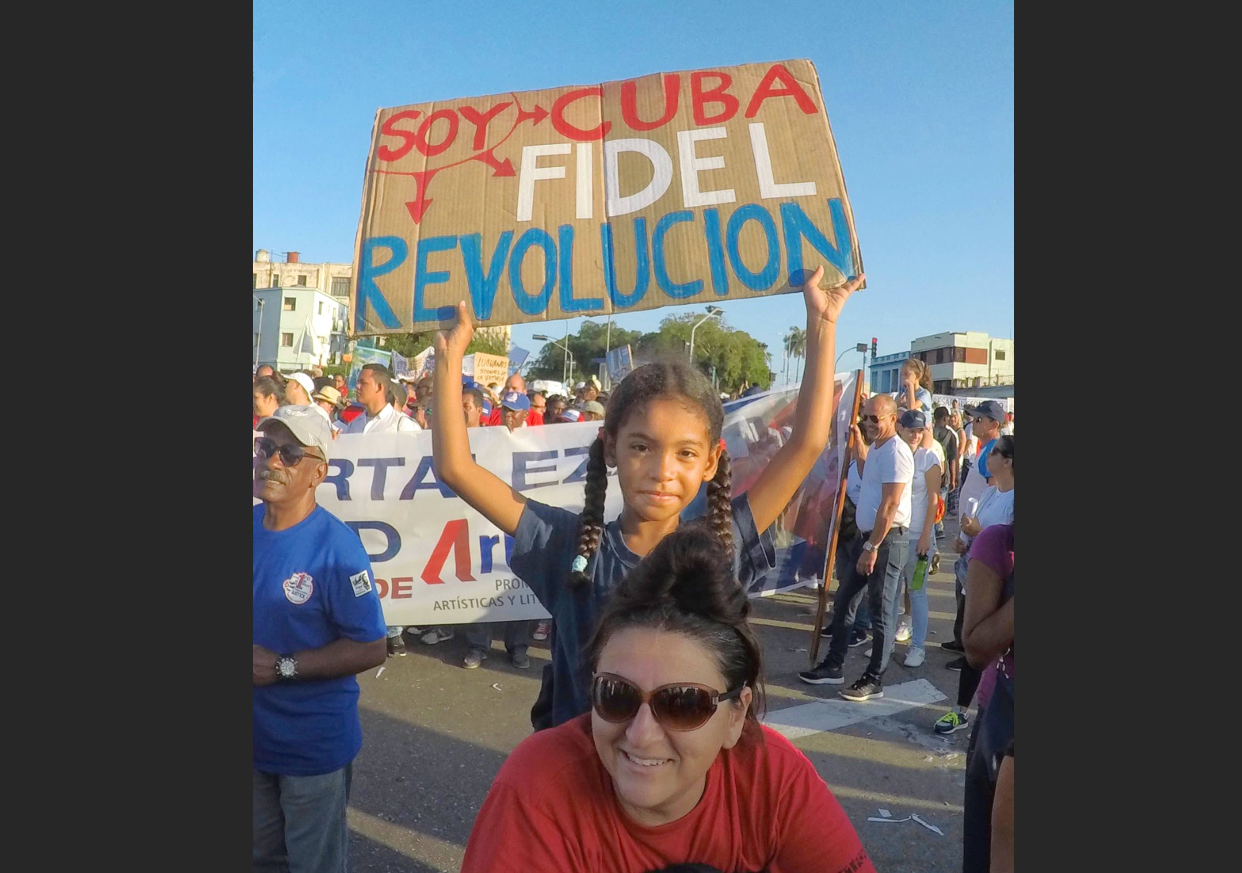 ‘I am Cuba, I am Fidel, I am Revolution’ A young girl holds up a sign at the May Day Parade in Havana
