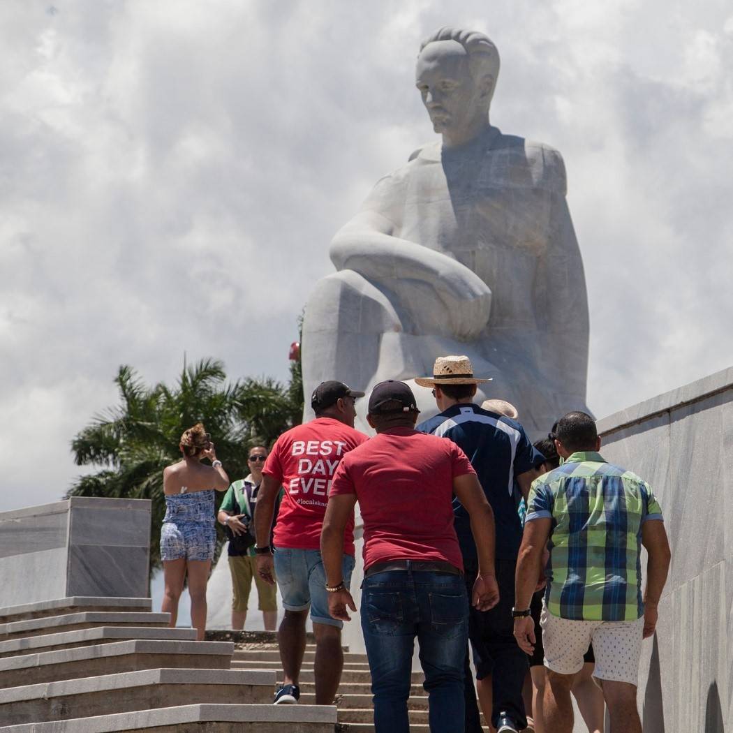 Jose Martí in the Plaza de la Revolucion, Old Havana where there is a memorial building housing a museum of his life crowd of tourists in front of a large statue of Jose Martí