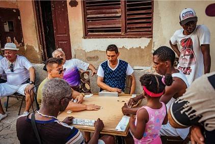 Live in the moment with an impromptu game of dominos a group plays dominoes in the street