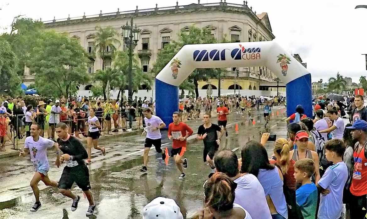 Marathon runners cross the finish line in the Marabana Havana Marathon