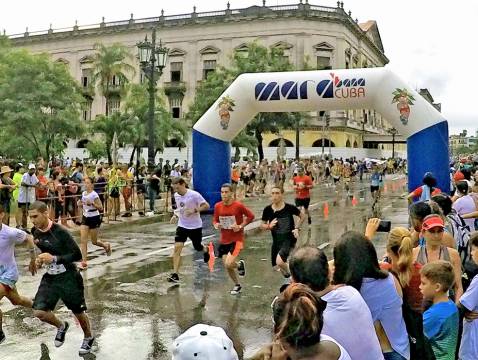 Marathon runners cross the finish line in the Marabana Havana Marathon
