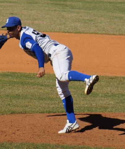 a baseball player pitches a ball