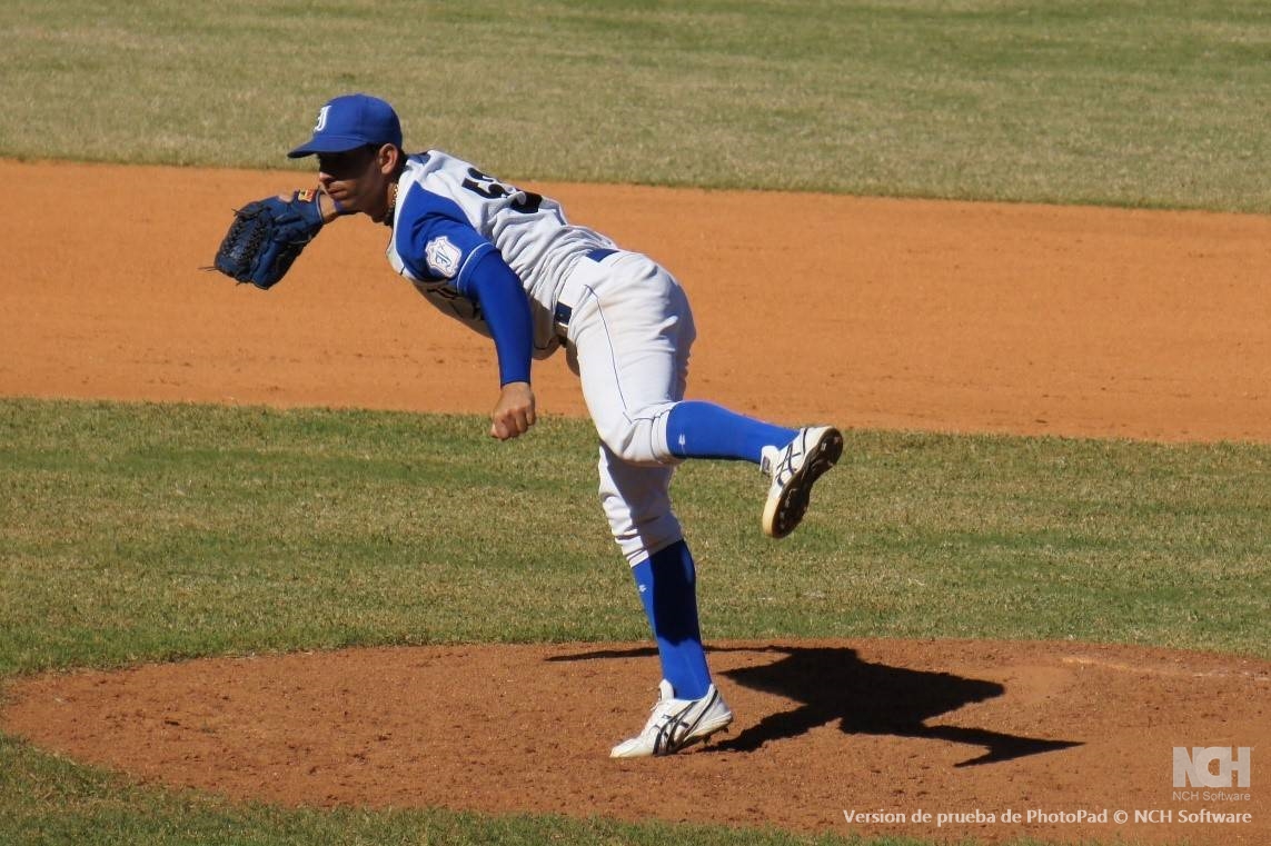 a baseball player pitches a ball