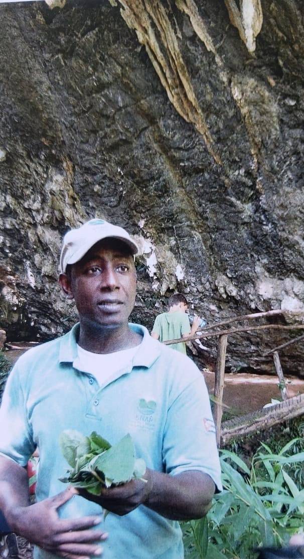 My past life as a guide in Topes de Collantes Omar holds a handful of leaves in a natural setting