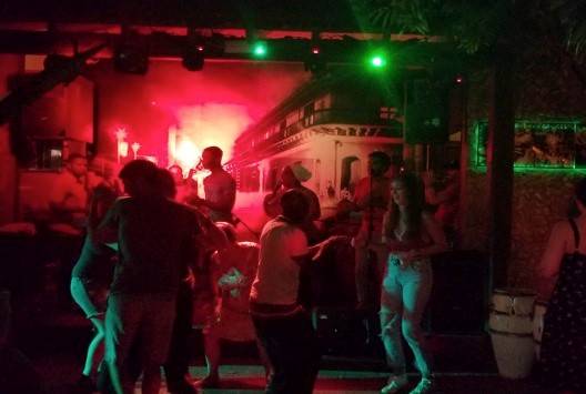 One of the popular open air life music venues in Trinidad a live band plays while people dance in a nightclub