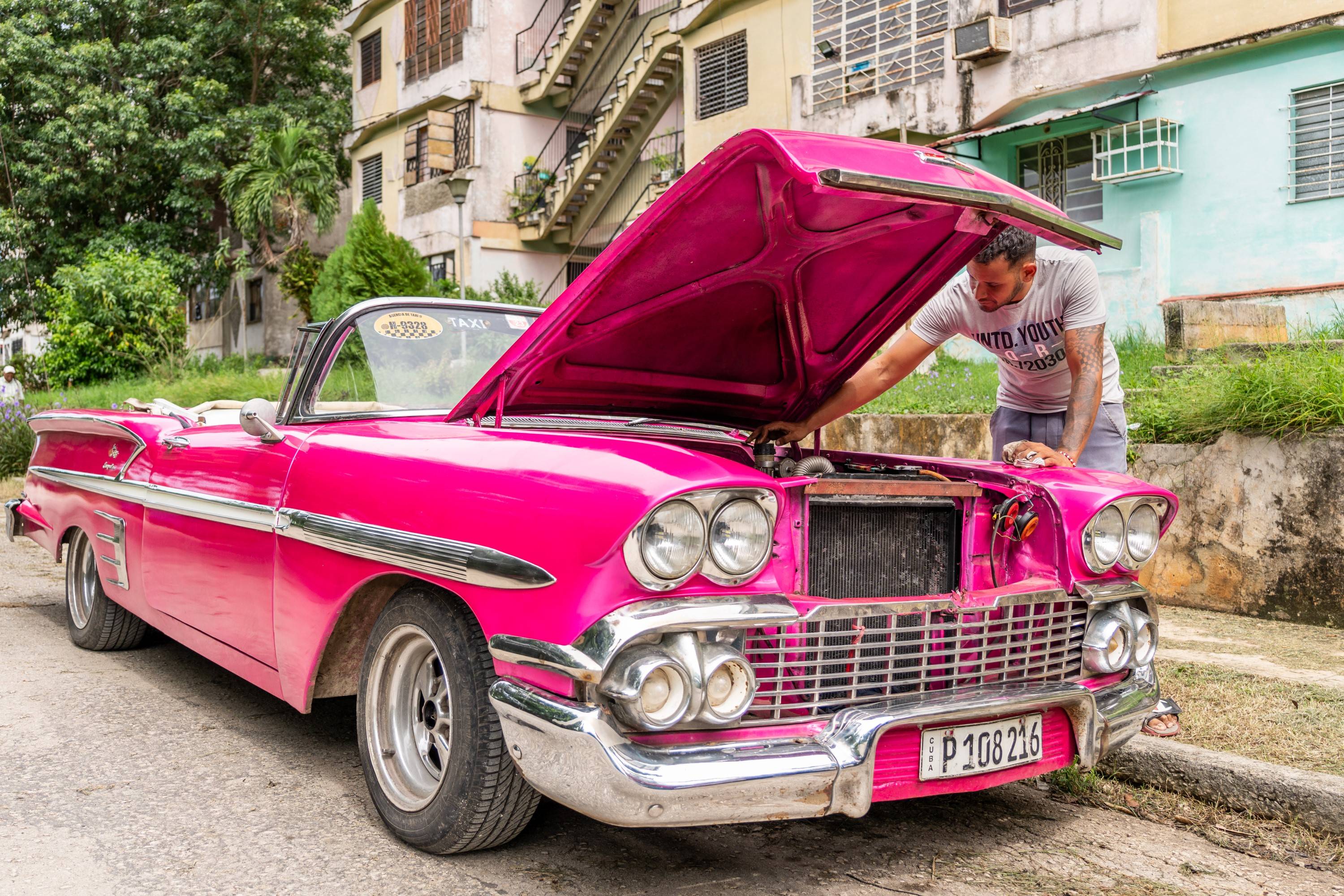 Pink classic car with open hood Pink classic car with open hood