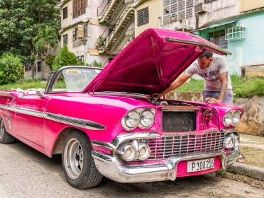 Pink classic car with open hood