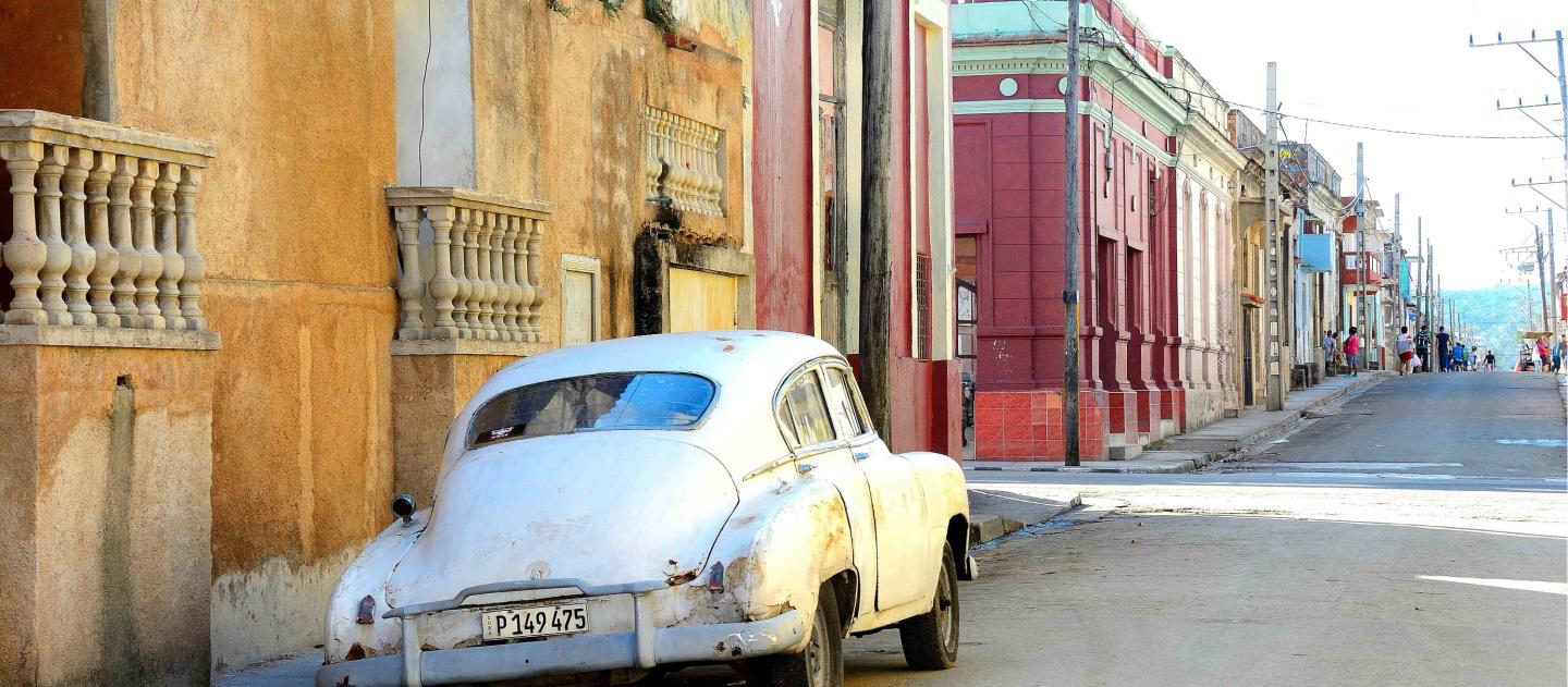An old car parked on a street of Santiago de Cuba