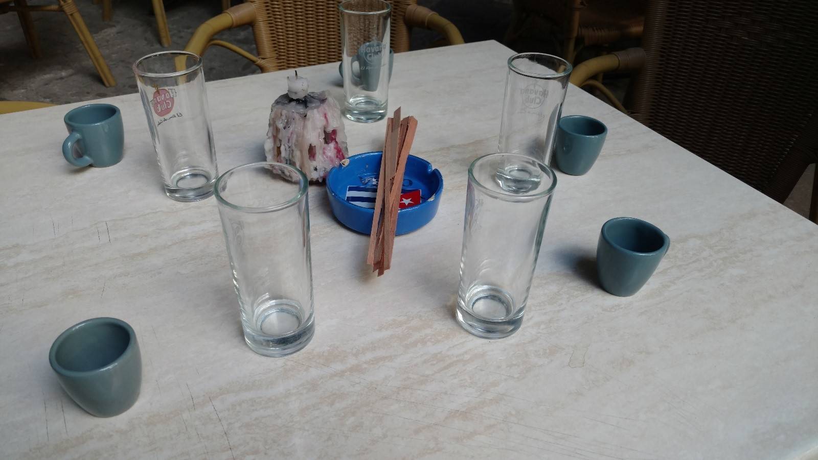 Set up for a maridaje ceremony coffee cups, rum glasses, and cedar sticks ready for a maridaje ceremony