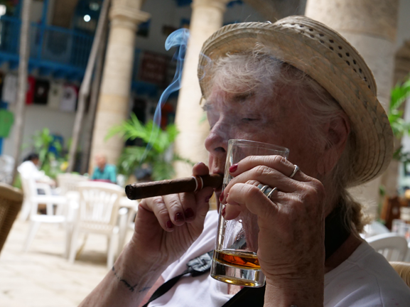 Smoking a Cuban cigar is a treasured experience. Photo credit: Saul Arizaga a woman smokes a cigar
