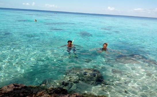 Snorkeling at the shores of the Fish Cave (Bay of Pigs) two snorkelers bob in the aquamarine waters of the Bay of Pigs