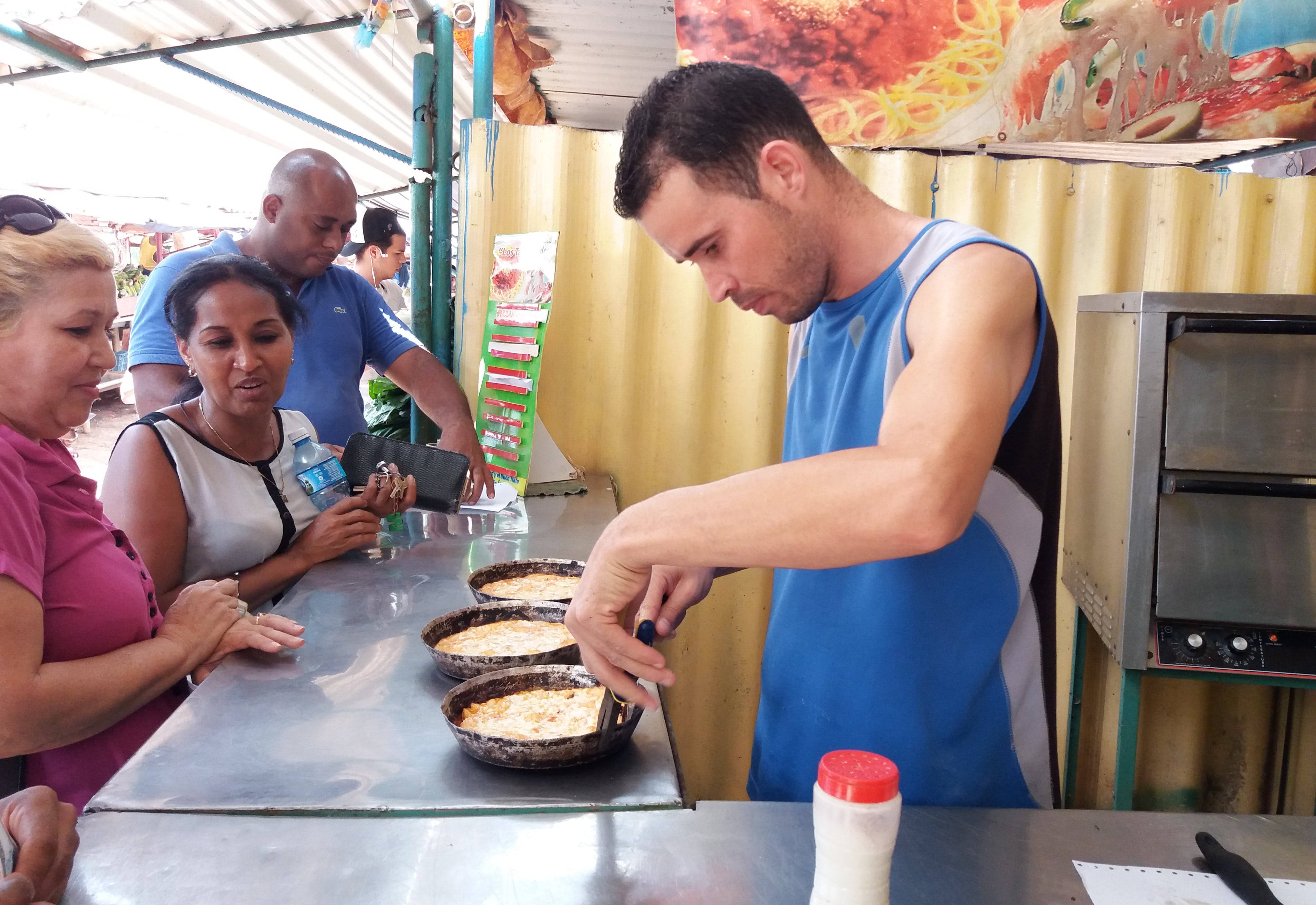 Street pizza is a popular snack in Cuba Pizza being served at a takeaway street stall in Cuba