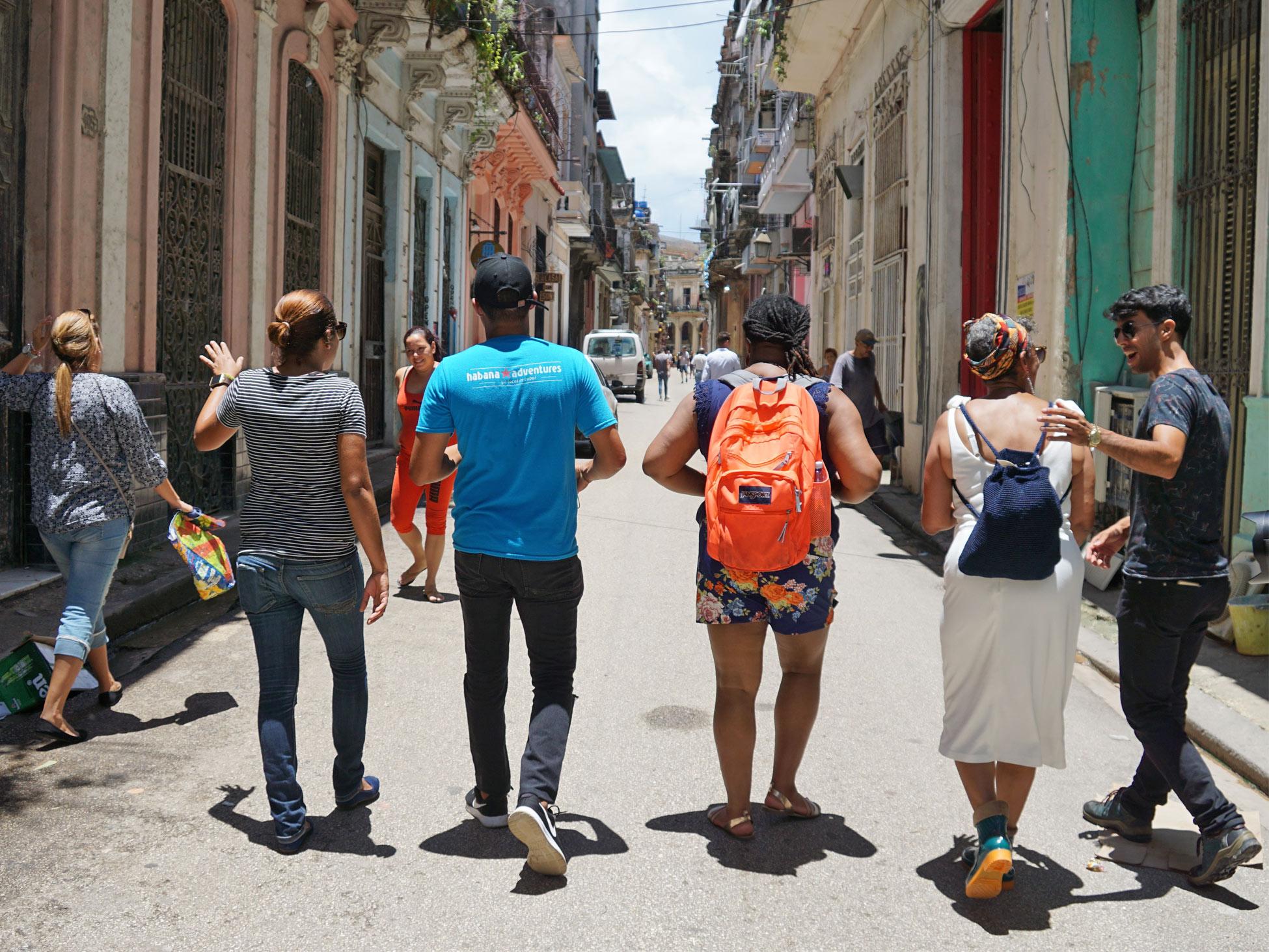 Team walking along Havana's street Team walking along Havana's street