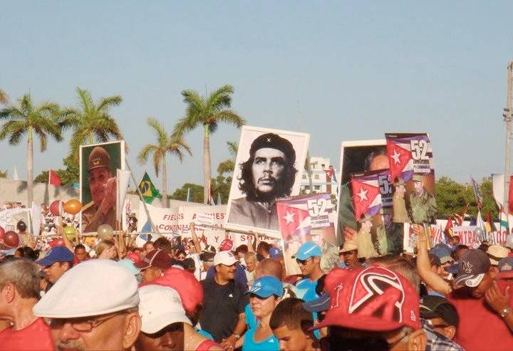 The crowd holds up images of political figures during the May Day Parade in Havana The crowd holding up images of political figures during the May Day Parade in Havana