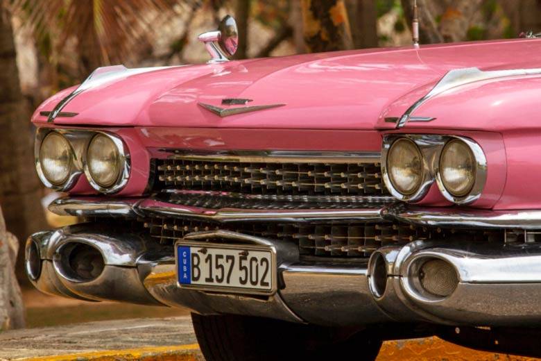 The front grille of a pink 1950's American car in Havana, Cuba The front grille of a pink 1950's American car in Havana, Cuba