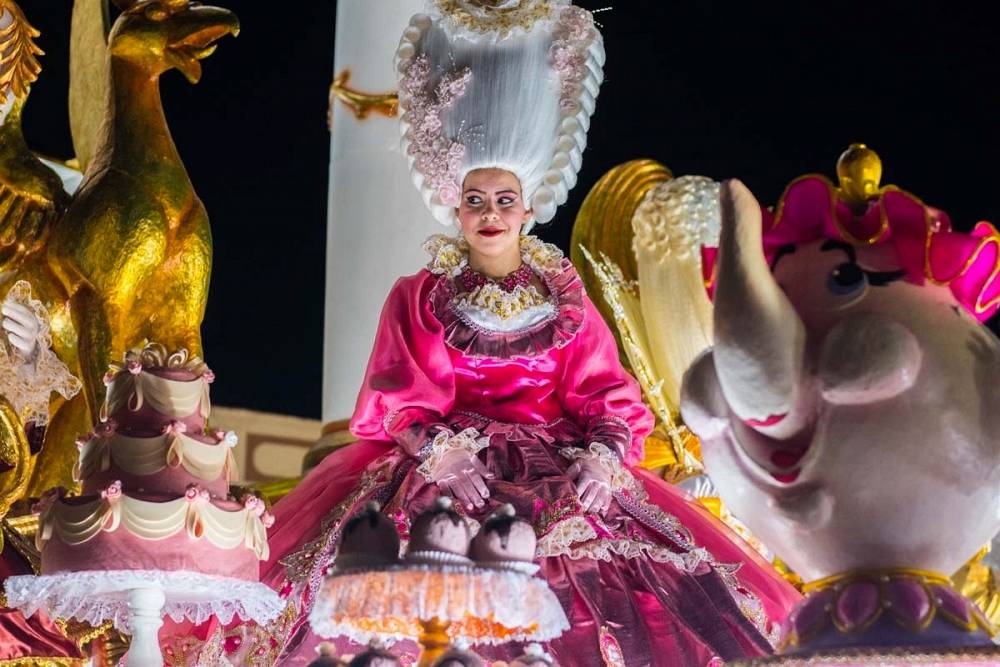 The two competing teams go all out with the costume decorations. A participant in the Parrandas de Remedios festival atop a carnival float.