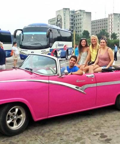 Tour guide Armando Lee Socarras with 3 happy customers in his Ford Fairline '56 that he and his father painted pink only recently.
