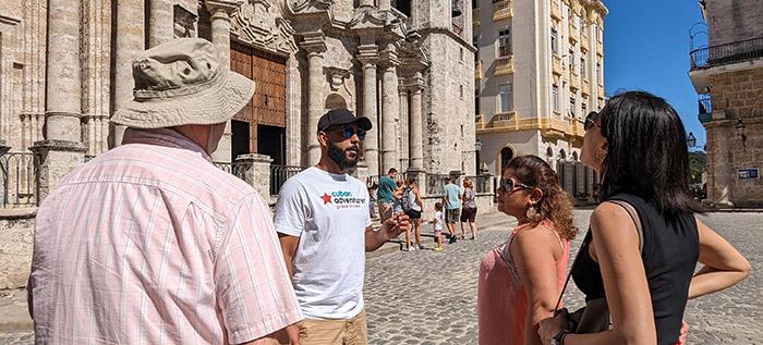 Tour leader with group in front of old building